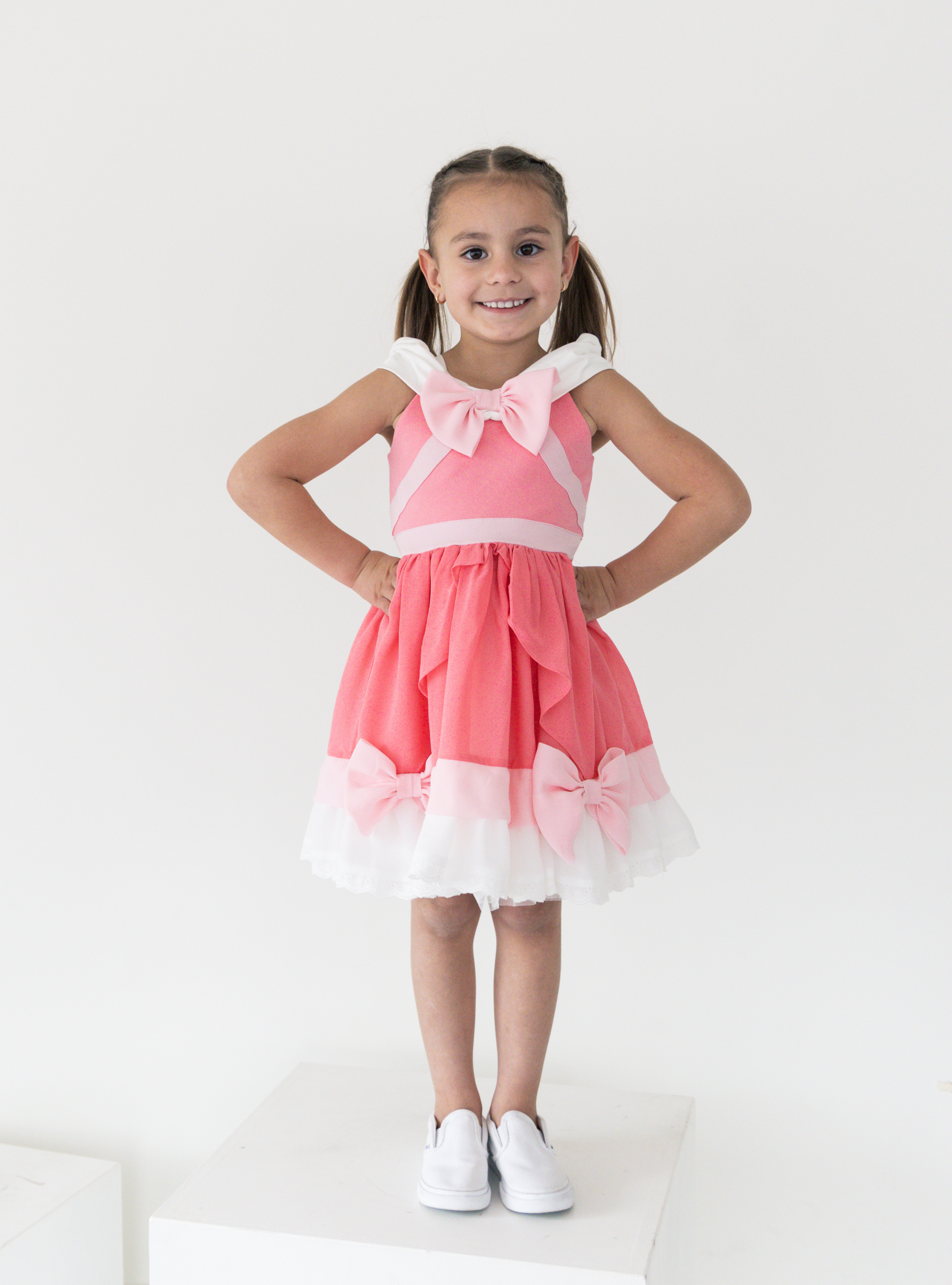 Disney and Taylor Joelle branded Pink Cinderella Dress. This dress is detailed with off the shoulder sleeves, bows, and different pink and white detailing.