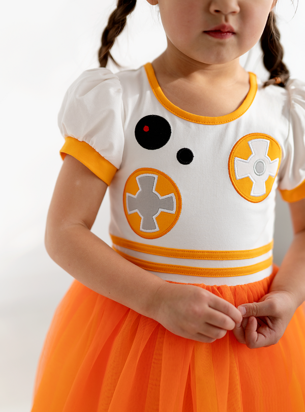 This dress features a robot desgin, complete with embroidered buttons and gadgets to form a detailed look!