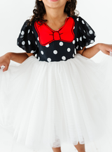 Can't get cuter than a black and white polka dot top, featuring a cute red bow!