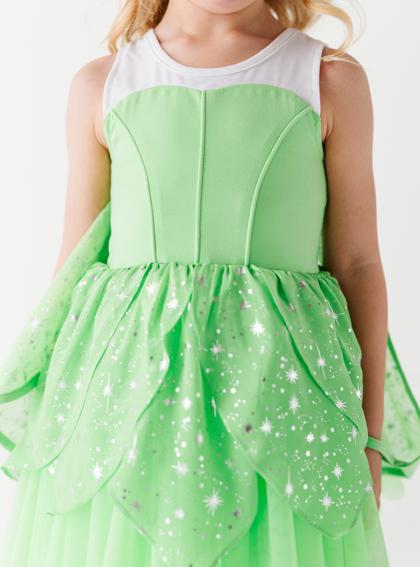 This dress features a cotton top, and a skirt complete with sparkle design and tulle underlays.