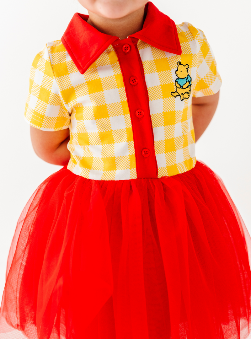 A closer look at the buttoned top, complete with a fun collar and a Winnie the Pooh design!