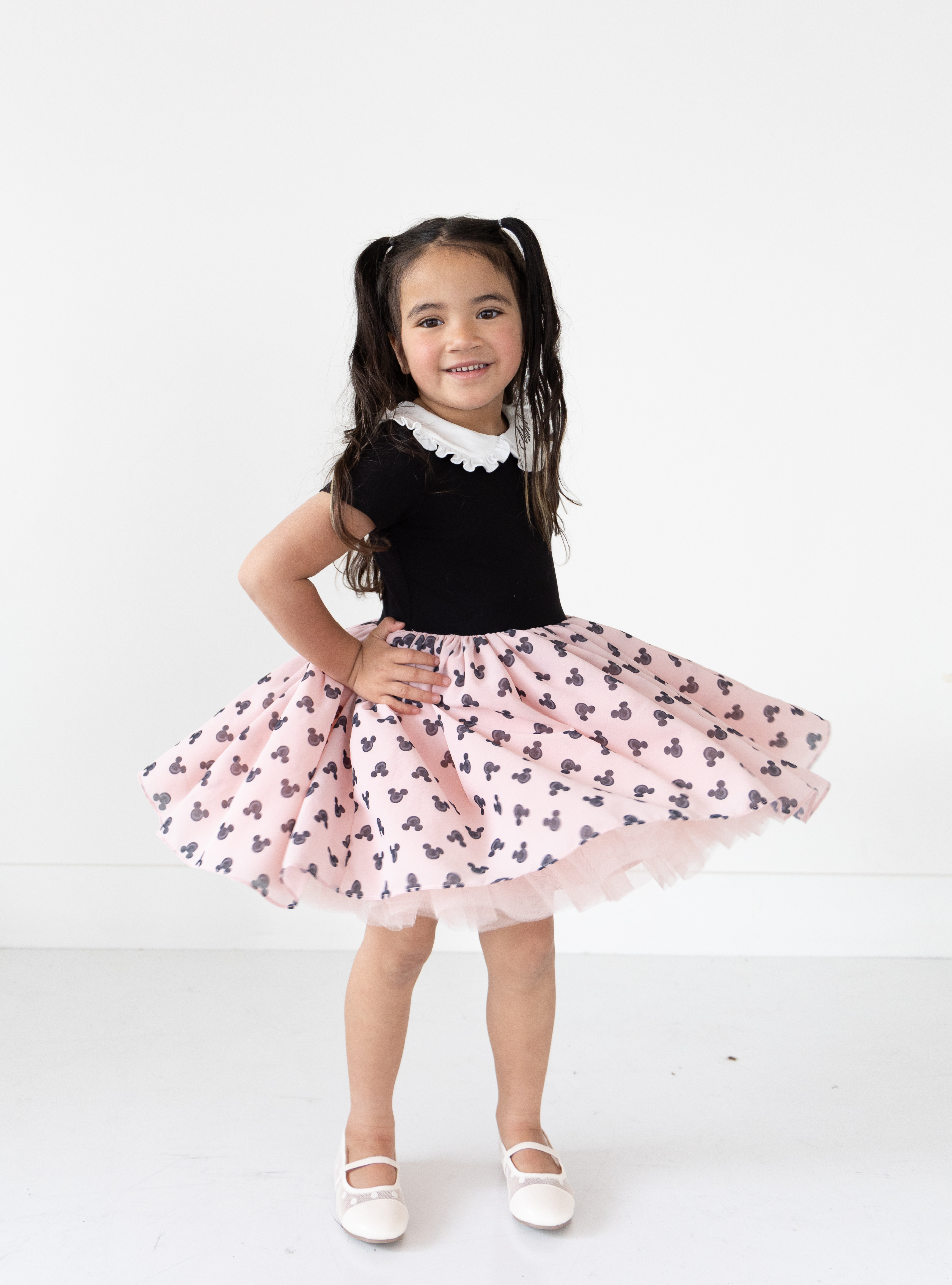 Disney and Taylor Joelle brand mickey mouse print on skirt of kids dress with ruffle and embroidered collar, short sleeves, and chiffon skirt