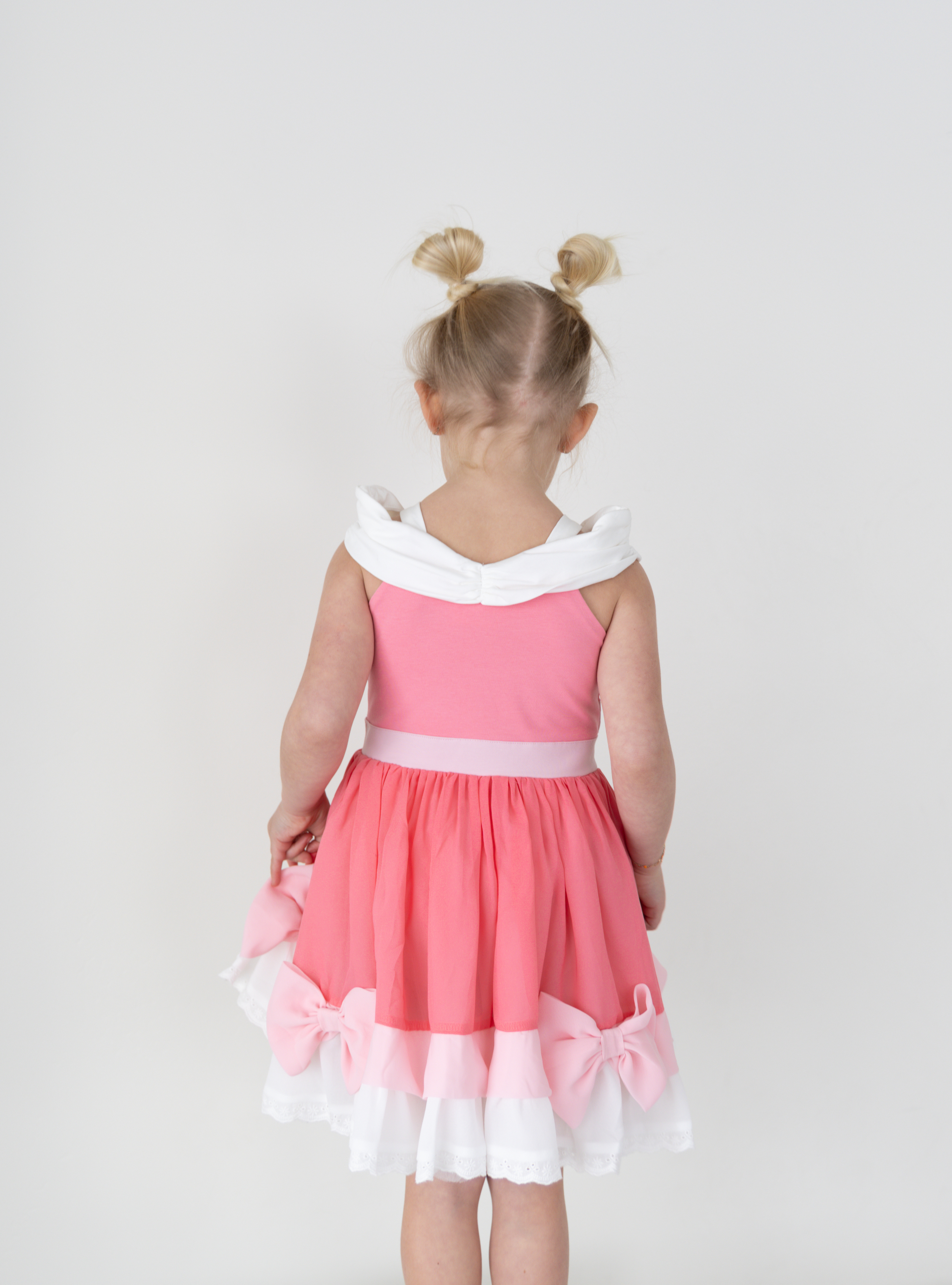 Disney and Taylor Joelle branded Pink Cinderella Dress. This dress is detailed with off the shoulder sleeves, bows, and different pink and white detailing.