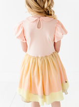 Buttoned back with a cotton bodice and chiffon and tulle skirt featuring a pastel Tatooine-inspired sunset.