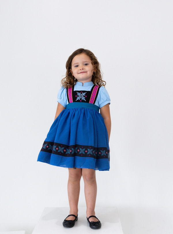 The model is showing the cute blue dress and shows what it looks like on a child. 