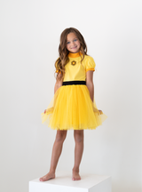 The superstar dress is a yellow goofy Powerline inspired dress. it has a black waistline and a symbol on the front. 