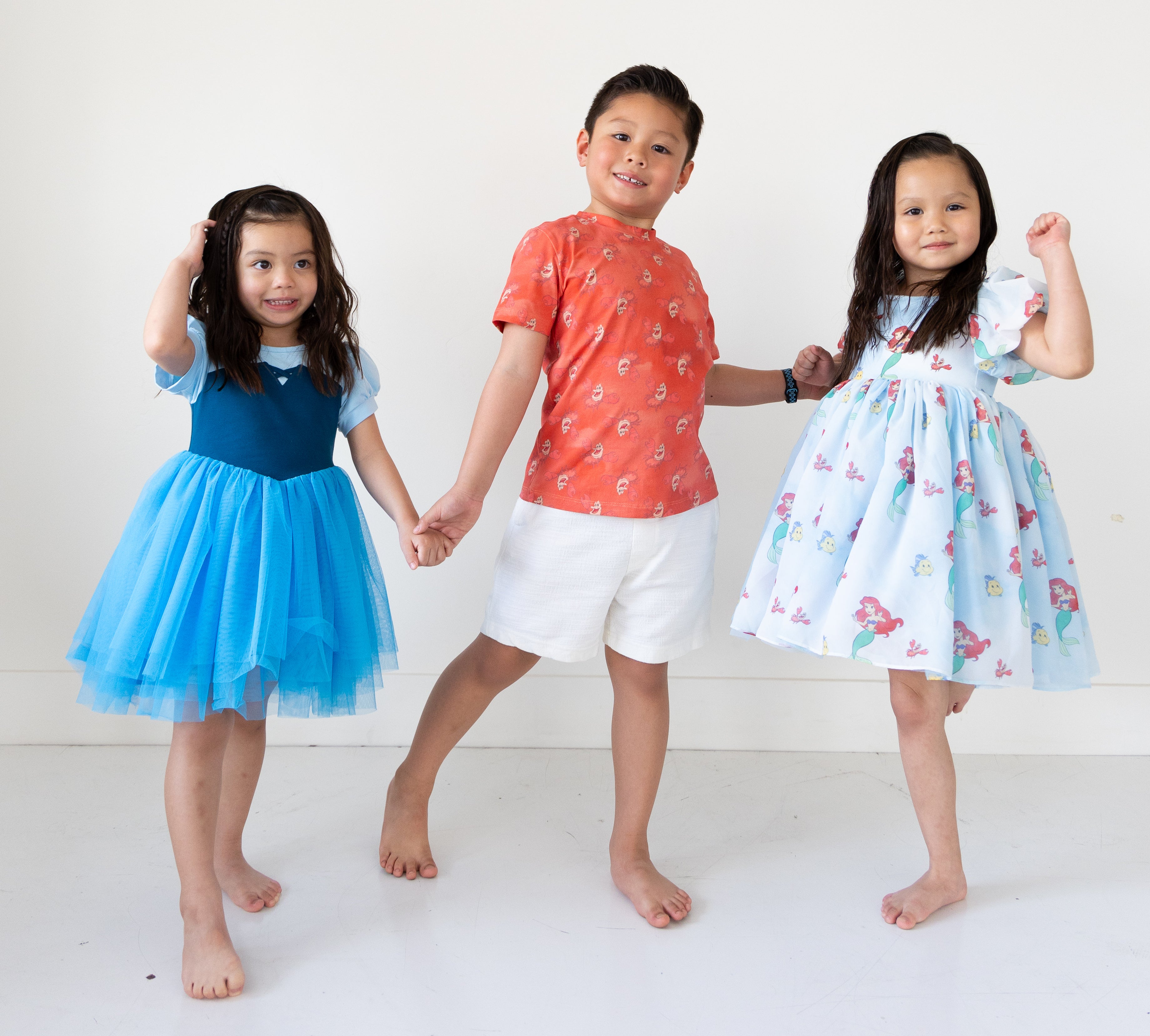 Disney and Taylor Joelle branded Ariel dress with a two-toned blue bodice and a bluet tulle skirt. Shown with the Sebastian Tee and another Ariel Dress.