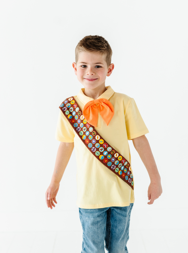 This Up-inspired tee is both comfortable and classy! Features a detachable orange necktie, fun collar, and an attached sash with screen-printed badges.
