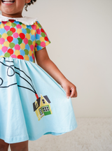 Features a screen-printed house design on the polyester skirt.
