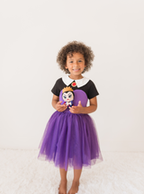 This dress features bold colors, with a purple torso and skirt, and a black and white top! 