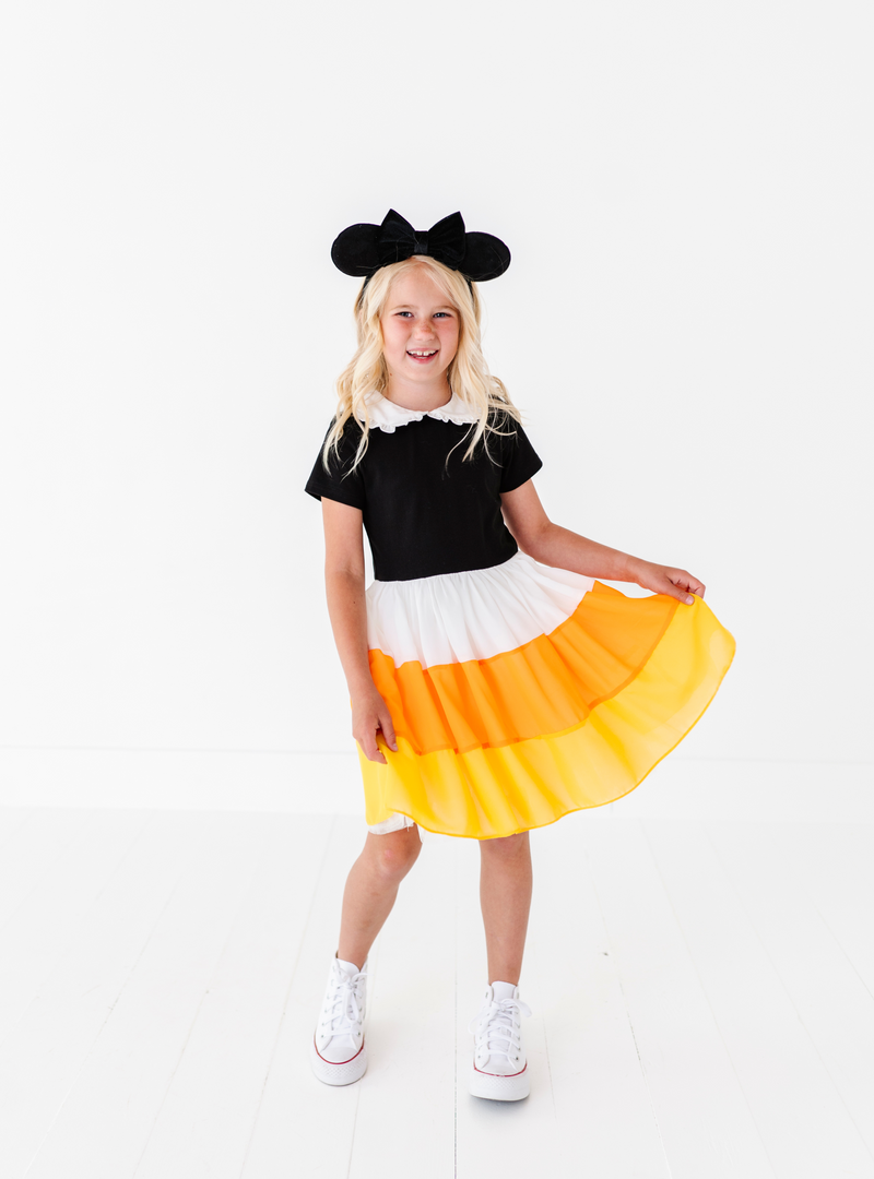 The chiffon skirt features a candy corn design with a white, orange and yellow stripe layering.