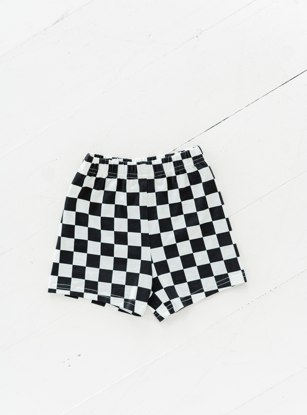 Made from cotton and featuring a cute black and white checkered design, these cartwheel shorts are perfect for play or for under dresses!