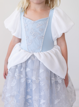 The bodice is complete with embroidered butterflies and detailed trim that match the skirt.