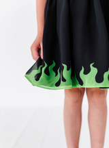 A closer look at the green flame design on the edge of the skirt.
