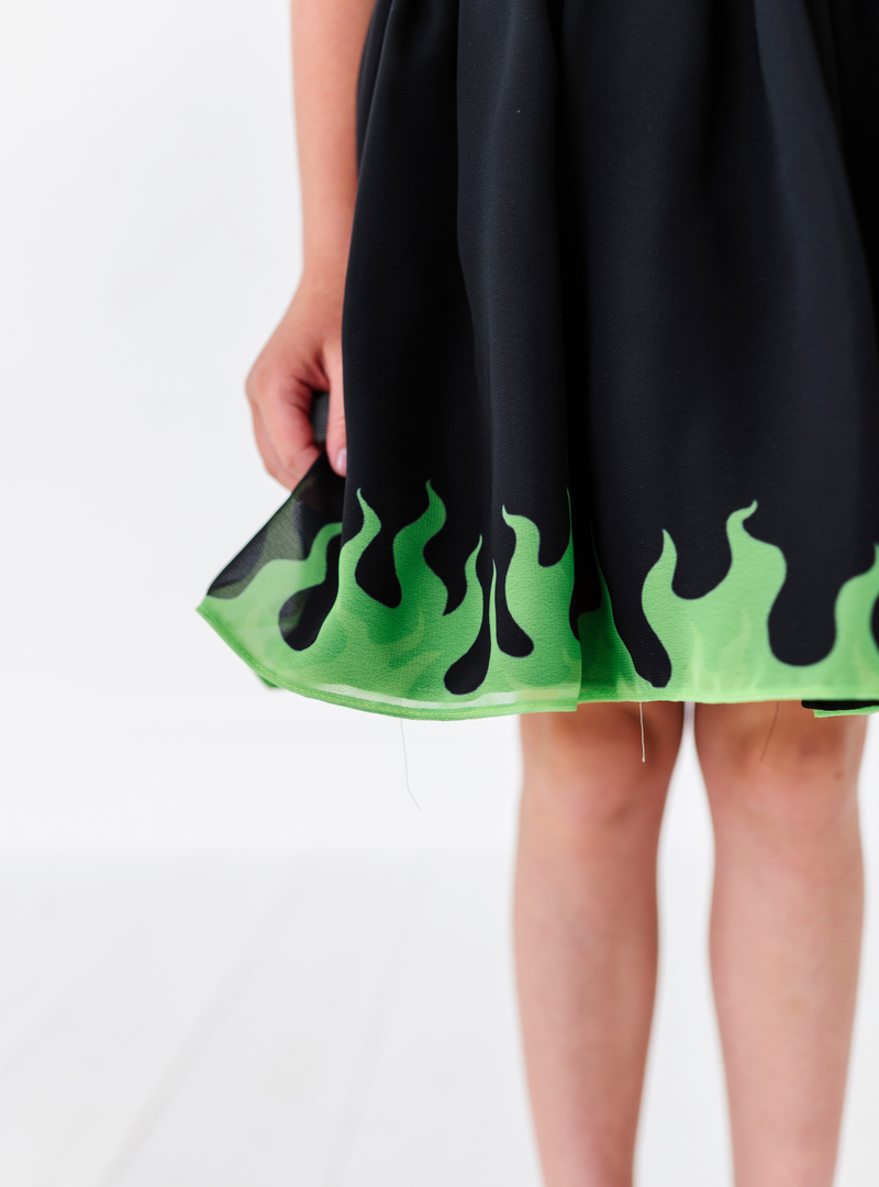 A closer look at the green flame design on the edge of the skirt.
