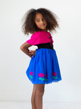 The Snowdrift Adventure Dress is full of vibrant colors including black, green, blue and pink!