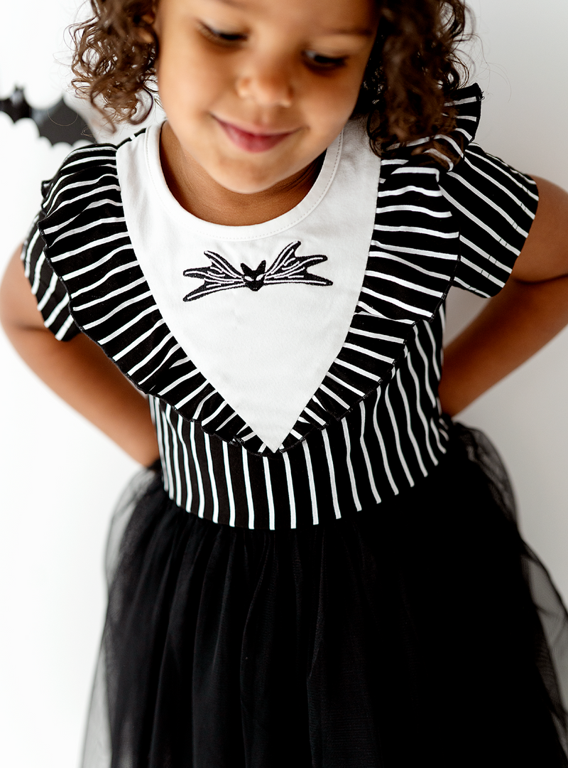 A closer look at the fun black and white stripe design and a spooky design in the center of the dress!