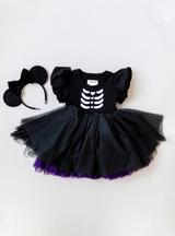 Features a black tulle skirt with purple tulle underlays!